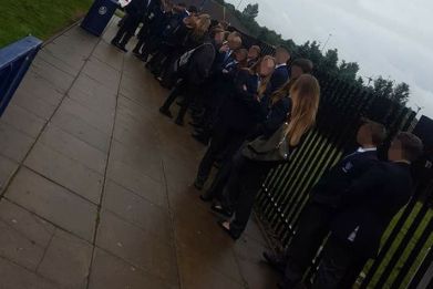 Pupils Kepier School in Sunderland line up in the rain to have their school uniforms inspected
