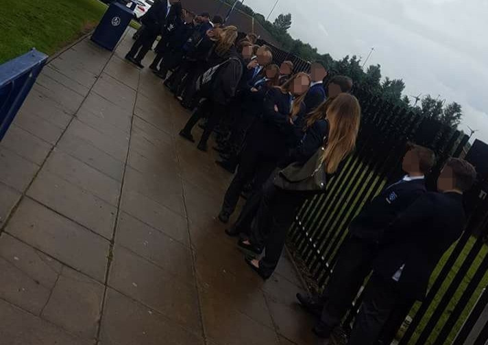 Pupils Kepier School in Sunderland line up in the rain to have their school uniforms inspected