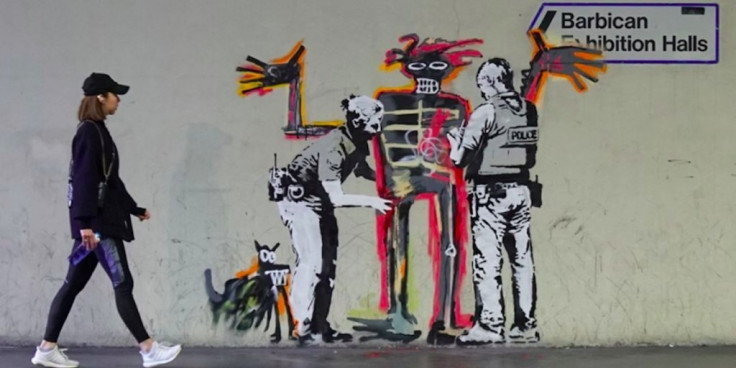One of two new murals by street artist Banksy that that mark the opening of an exhibition by American artist Jean-Michel Basquiat in central London One of two new murals by street artist Banksy that that mark the opening of an exhibition by American artist Jean-Michel Basquiat in central London
