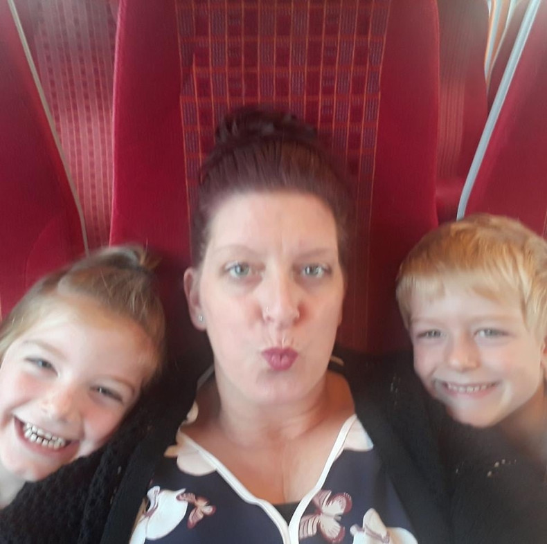 Gayna Pealling and her children, Jack and Amy, enjoy their train journey, which saw them helped by passing stranger Daniel Ball