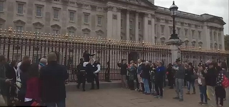 Woman climbs gates at Buckingham Palace