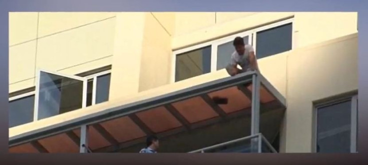 Man dangling off rooftop in Sydney