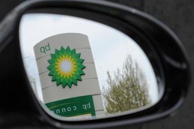 A British Petroleum logo is seen reflected in a car mirror at a petrol station in south London