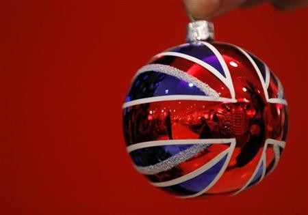 Selfridges employee Anisha Rethdawala poses with a Union flag themed tree ornament in Selfridges Christmas shop as it opens for business 145 days ahead of Christmas Day in central London