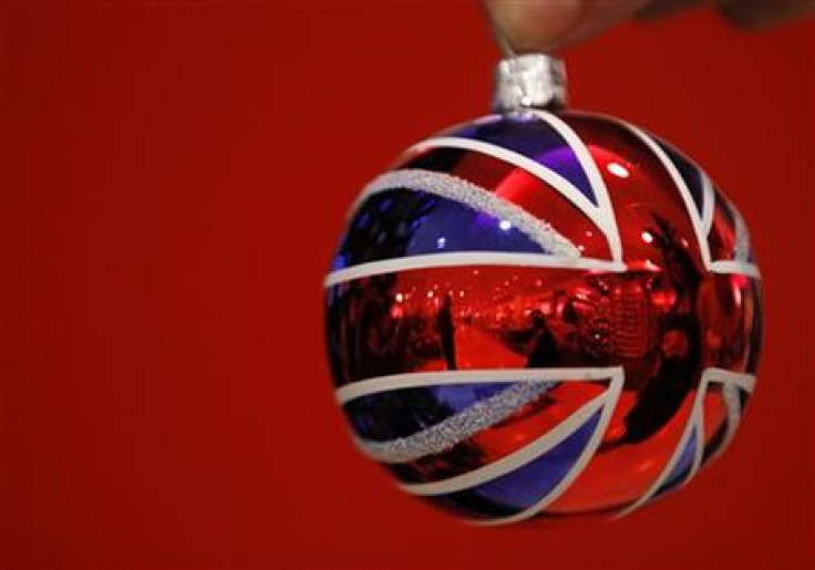 Selfridges employee Anisha Rethdawala poses with a Union flag themed tree ornament in Selfridges Christmas shop as it opens for business 145 days ahead of Christmas Day in central London