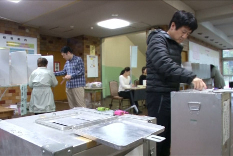 Japanese Voters Head To The Polls As Typhoon Lan Batters Country