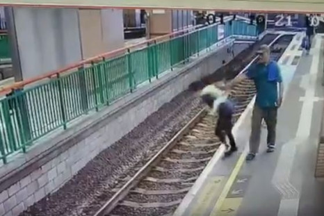Man pushes woman on rail tracks HongKong