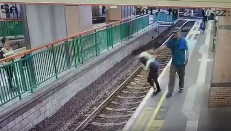 Man pushes woman on rail tracks HongKong