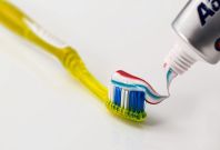 Toothbrush topped with toothpaste