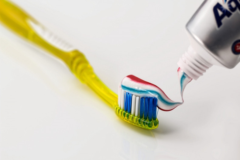 Toothbrush topped with toothpaste