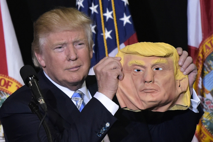 Donald Trump holds mask of his face