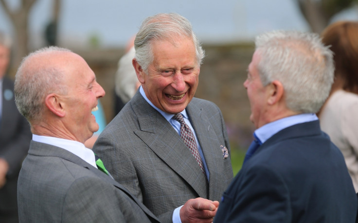 Prince Charles, Prince of Wales laughs as he is introduced to Lord Mountbatten's former staff by Peter McHugh (L) during a visit to the peace garden on May 20, 2015 in Sligo, Ireland