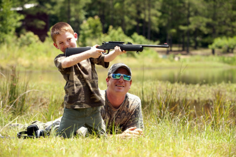 Hunter helps son with target practice 