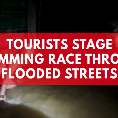 Tourists Stage Swimming Race Through Flooded Street
