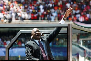 Kenya's President Uhuru Kenyatta waves upon his arrival to his inauguration ceremony where he will be sworn in as president at Kasarani Stadium in Nairobi, Kenya