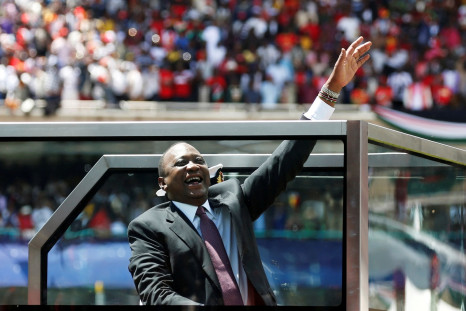 Kenya's President Uhuru Kenyatta waves upon his arrival to his inauguration ceremony where he will be sworn in as president at Kasarani Stadium in Nairobi, Kenya