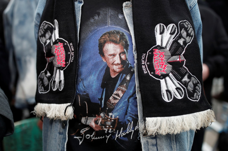A fan of Johnny Hallyday pays his respects outside the late French singer’s home in Marnes-la-Coquette near Paris, France, December 6, 2017