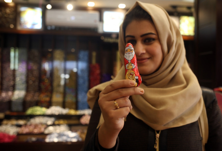 A Muslim woman with a Santa chocolate