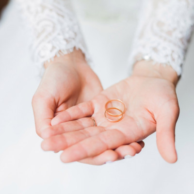 A bride holds wedding rings