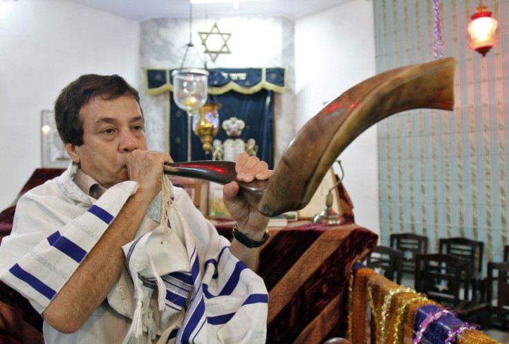 Ezekiel Isaac Malekar, honorary secretary of the Judah Hyam Synagogue synagogue, poses with a shofar horn inside the synagogue in New Delhi