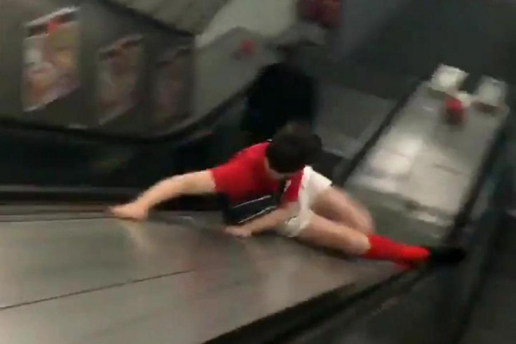 Darts fan Freddie Andrews takes the quick route down a London Underground escalator at London Bridge station