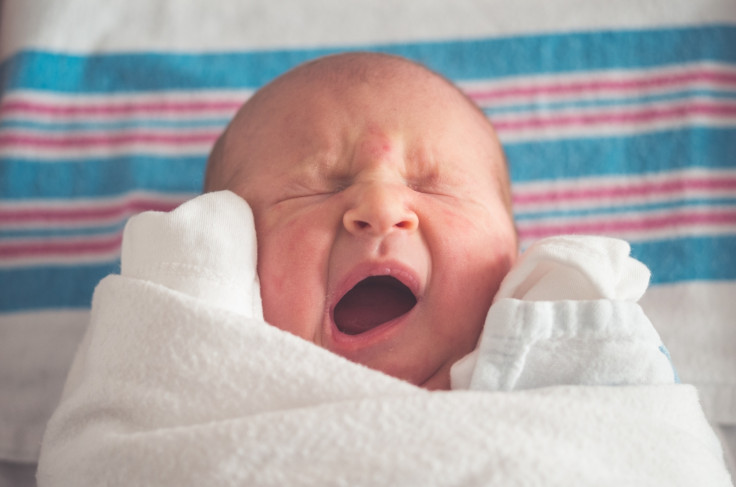 A newborn baby yawning