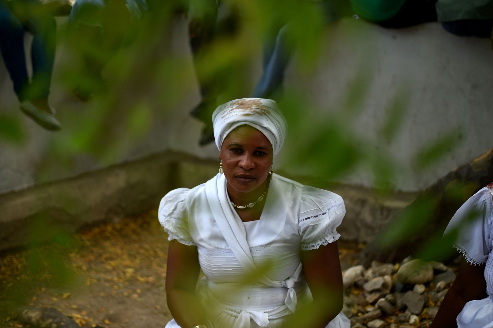 Haitian voodoo follower wearing white clothes