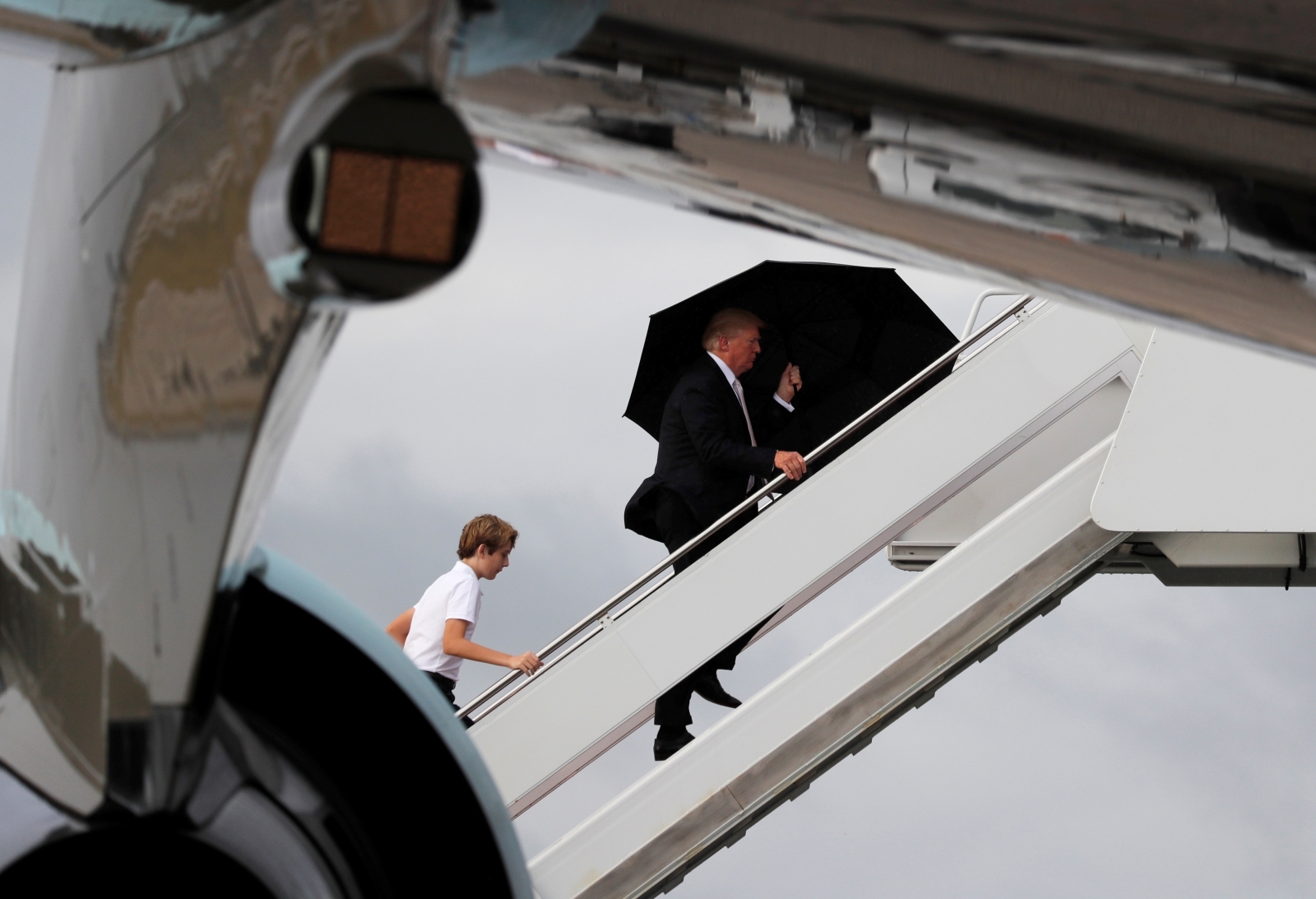 us president donald trump his son barron his wife melania behind out shot board air force one