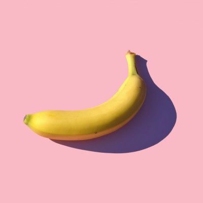 A banana on a pink background