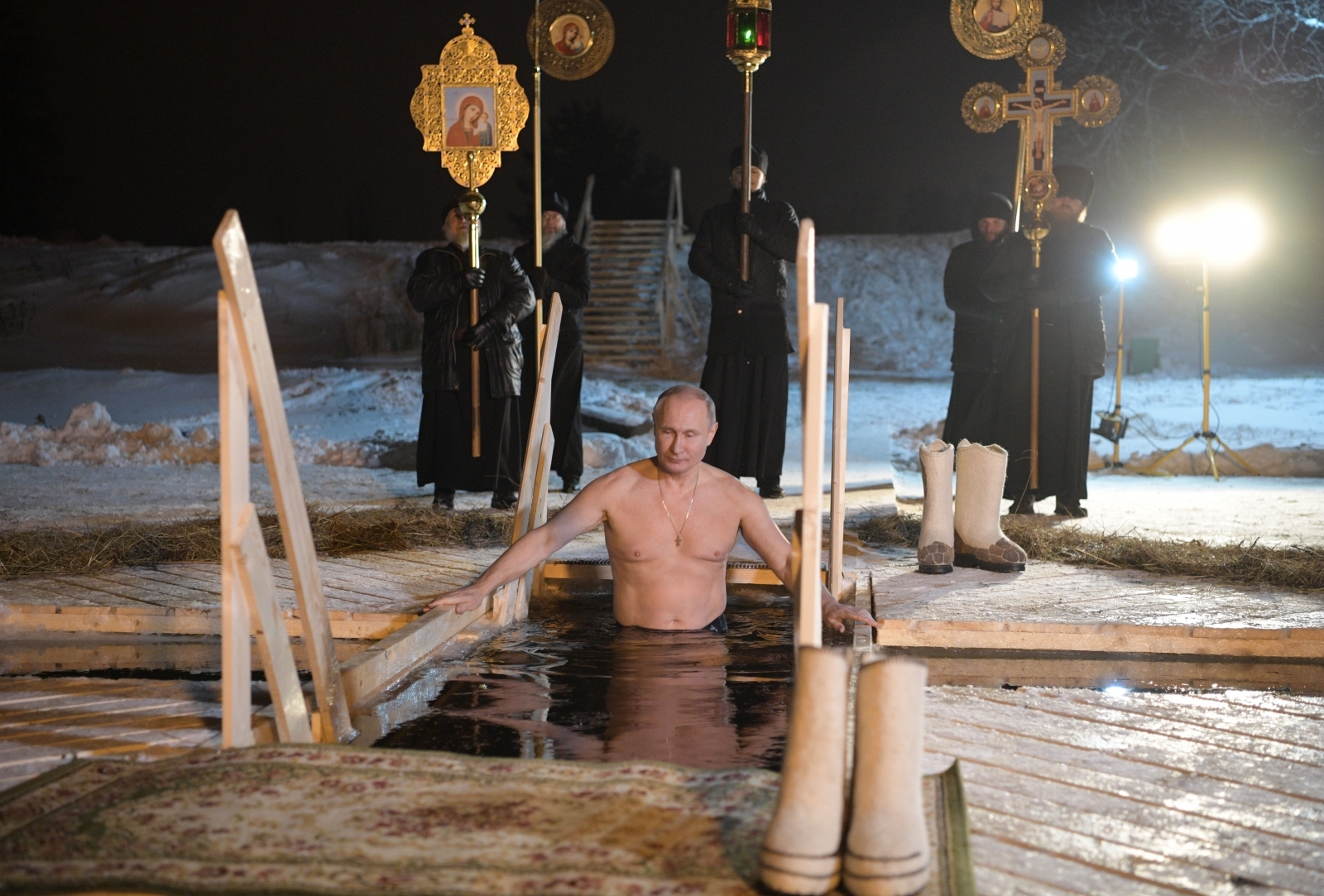 Russian President Vladimir Putin strips off and plunges into ice hole