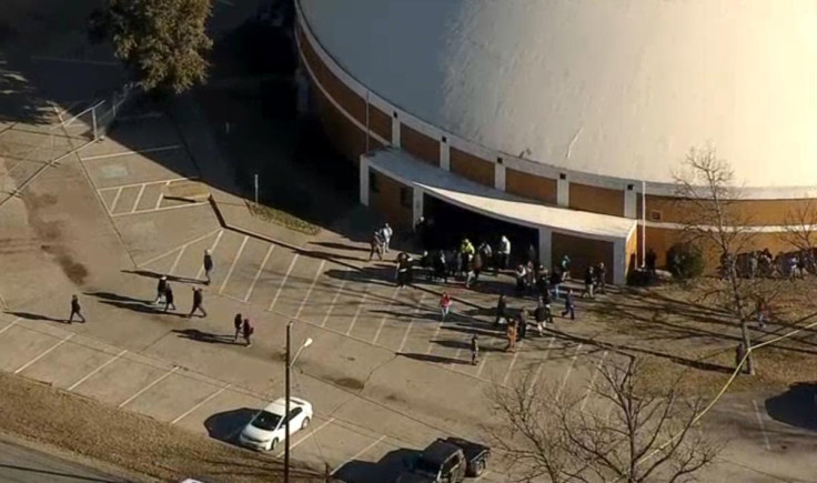 Students spill out of the Italy High School cafeteria where a teenage gunman shot the 15-year-old girl he recently broke up with