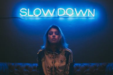 Woman in front of neon sign