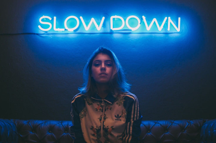 Woman in front of neon sign