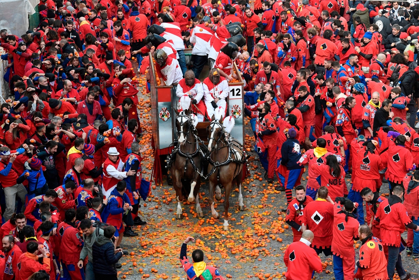 Giant food fight as thousands throw fruit in medieval Battle of the Oranges