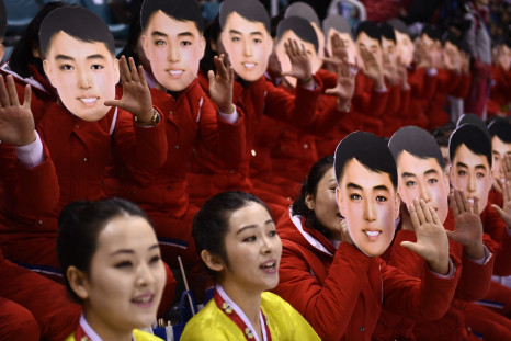 North Korean cheerleaders wearing Kim Il-sung masks