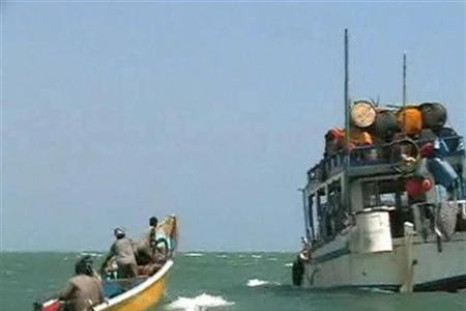 Pirates on speedboat approach one of their mother boats docked near Eyl, Somalia