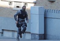 A Belgian police special forces officer runs in the Forest district after it was closed by Belgian police hunting a gunman A Belgian police special forces officer runs in the Forest district after it was closed by Belgian police hunting a gunman