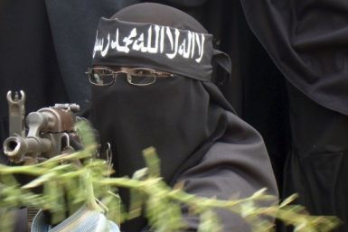 A woman Al Shabaab fighter points a gun during a demonstration, against the African Union Mission in Somalia.