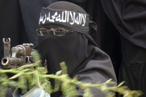A woman Al Shabaab fighter points a gun during a demonstration, against the African Union Mission in Somalia.