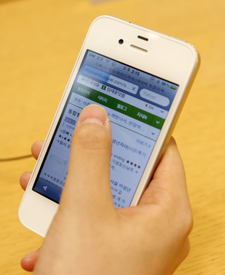 A woman uses an Apple iPhone 4 smartphone for Web surfing