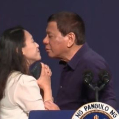 Philippine President Duterte kisses woman