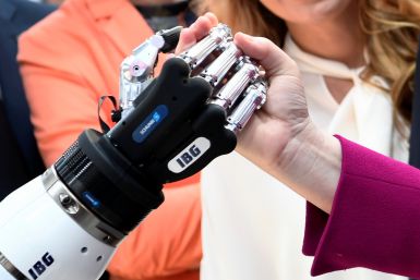 German Chancellor Angela Merkel shakes hands with a humanoid robot
