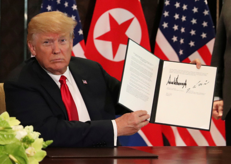 U.S. President Donald Trump shows document