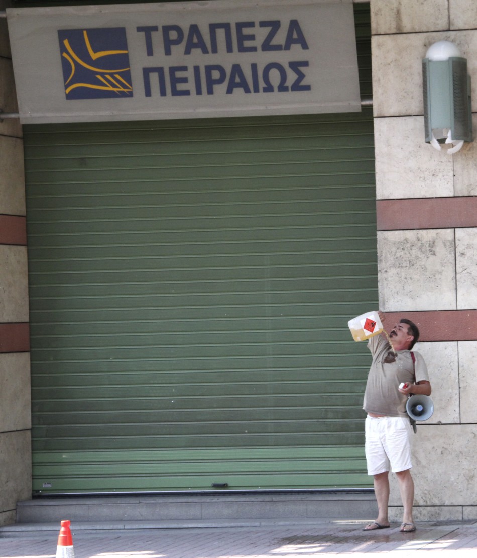 A man pours a flammable liquid on his body to set himself on fire outside a Piraeus bank branch in Thessaloniki in northern Greece