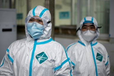 Medical workers wear hazmat suits