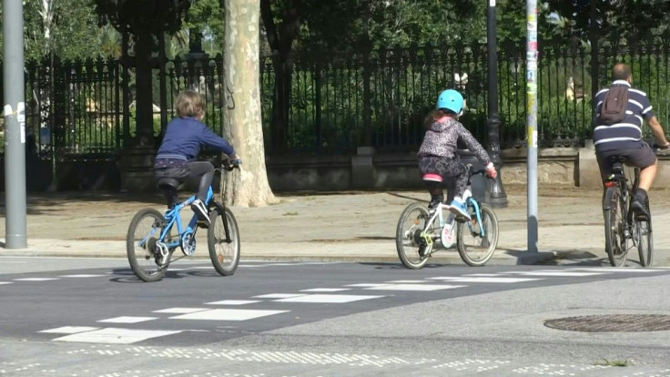 Spanish children ride bicycles 