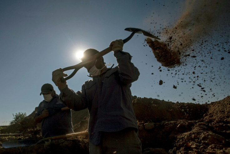 Cemetery workers dig graves