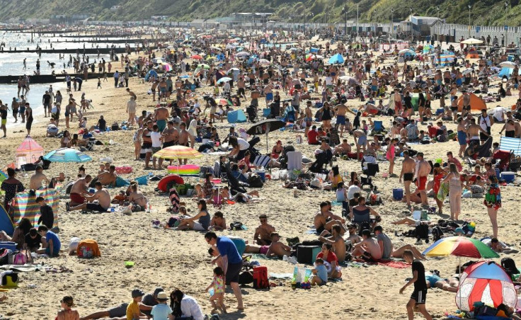 Crowds flock to a beach in Bournemouth, England,