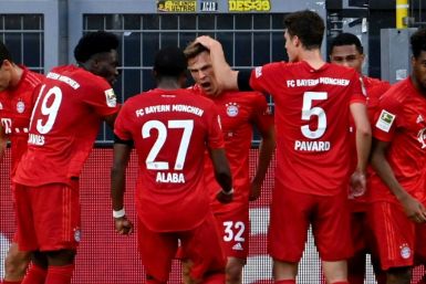 Bayern Munich midfielder Joshua Kimmich (C) celebrates scoring the winning goal at Borussia Dortmund. POOL / Federico GAMBARINI