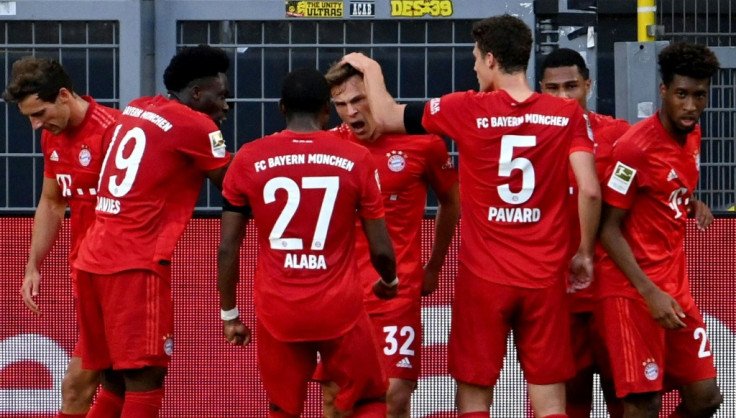 Bayern Munich midfielder Joshua Kimmich (C) celebrates scoring the winning goal at Borussia Dortmund. POOL / Federico GAMBARINI